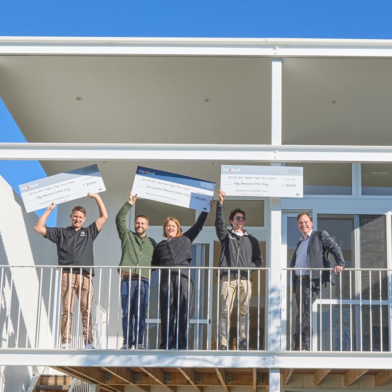 Steel The Show - Grand Prize Winners - People Standing on a double story house balcony, photo taken from the street